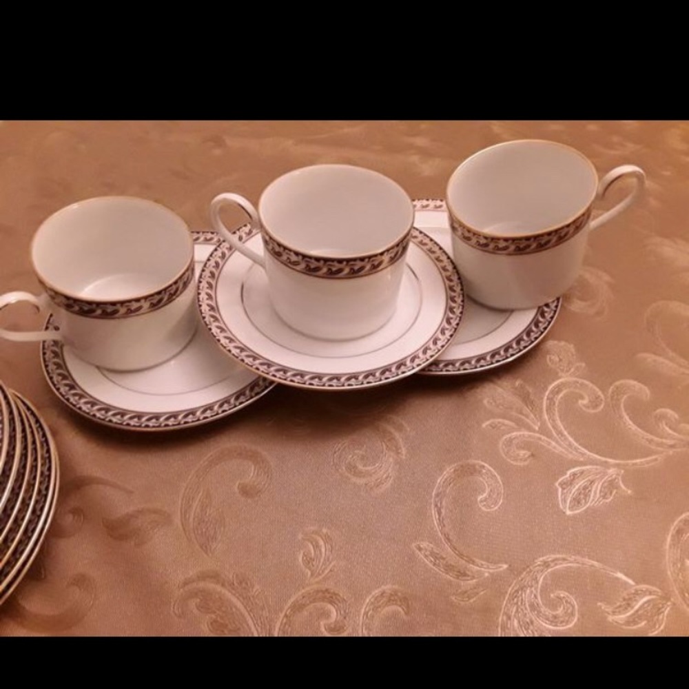 7 tea cups with tea saucers and 6 small desserts